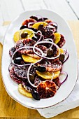 A citrus salad with olives and onions