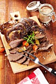 Roast leg of venison with rosemary, leek and carrots