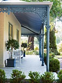 Roofed veranda with metal pillars and ornate details