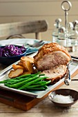 Roast pork with green beans, potatoes and red cabbage