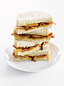 A stack of bacon and onion sandwiches