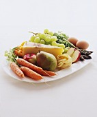 Vegetables, fruit, cheese, pasta and eggs on a serving platter
