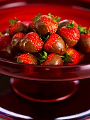 Chocolate strawberries in a red bowl