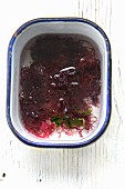 A bowl of red seaweed with water