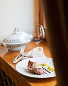 Wild boar roulade with fennel, orange jelly and olive sauce on a table (Restaurant Da Caino, Head Chef Valeria Piccini)