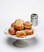 Doughnuts filled with vanilla cream and dusted with icing sugar