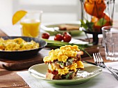 Taosted bread topped with scrambled eggs for breakfast