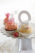 Three romantic cupcakes on a cake stand