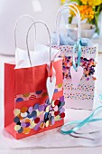 Gift bags decorated with confetti and washi tape