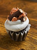 A chocolate cupcake decorated with a chocolate bar