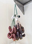 A bundle of chorizo (Spanish sausages) hanging on a butcher's hook