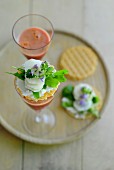 Canapes with vegetables and herbs and glasses of carrot juice