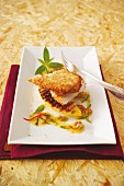 Guinea fowl escalope with a coconut coating served on grilled mango
