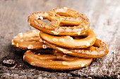 A stack of salted pretzels on a wooden surface