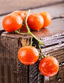 Freshly washed vine tomatoes on a wooden crate