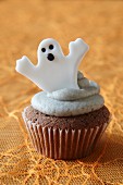 A cupcake decorated with a ghost for Halloween