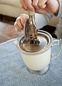 Cream being whipped with an old hand mixer