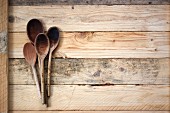 Wooden spoons on a wooden surface
