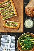 Asparagus cake, courgette and bean salad, a loaf of bread and lemon water on a picnic table