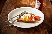 A poached egg on wholemeal toast with cherry tomatoes