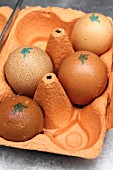 Brown eggs with stamps in an egg box