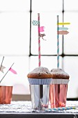 Drinking straws with washi tape flags stuck in muffins