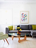 Classic coffee table in front of grey sofa and next to fifties armchair