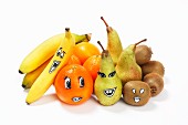 Various different fruits with faces