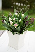 Vase of tulips on garden table