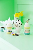 Easter arrangement; eggs decorated with washi tape, feathers and spring flowers