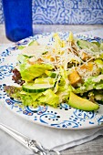 A Caesar salad with avocado, tempeh and Parmesan cheese