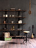 Crockery on open shelves, vintage bar stool and rustic wooden crates