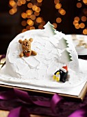 A ski slope cake with a reindeer and a penguin