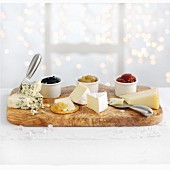 A cheese platter with various preserves for Christmas