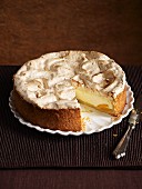 A cheesecake topped with meringue, sliced