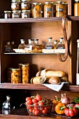 Jars, bread and fresh vegetables in a pantry