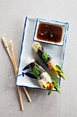 Rice paper rolls filled with vegetables and served with soy sauce