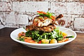 Roast organic chicken on a salad of rocket, cherry tomatoes in balsamic dressing and roast potatoes