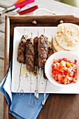 Kebabs with tomato salad and pita bread