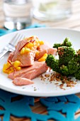 Salmon fillet with peach sauce and broccoli