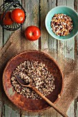 Wild rice, assorted beans and tomatoes on an old wooden table