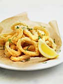 Deep-fried squid rings with wedge of lemon