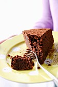 A slice of chocolate cake with a bite taken out