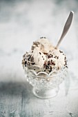 Vanilla ice cream with chocolate sprinkles in a glass bowl