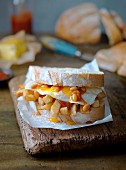 A fried egg, baked beans and chip sandwich