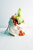 Cherry tomatoes and wrapped food in a shopping bag