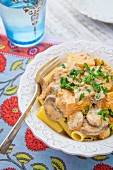 Tofu stroganoff with mushrooms and parsley on a bed of pasta
