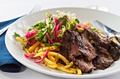 Beef with chips and a mixed leaf salad