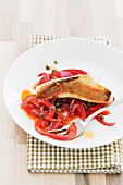 Gurnard fillet on a pepper and onion medley with capers