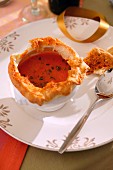 Festive tomato soup with a bread lid